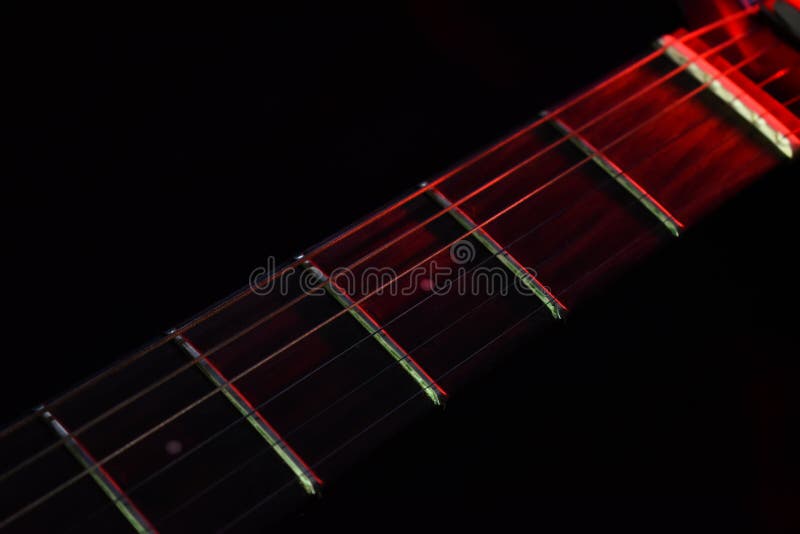 Electric Guitar Neck with a Cool Guitar Pick in Dark Background Stock
