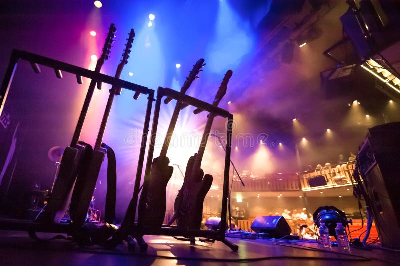 Electric guitars on stage editorial photography. Image of spotlights