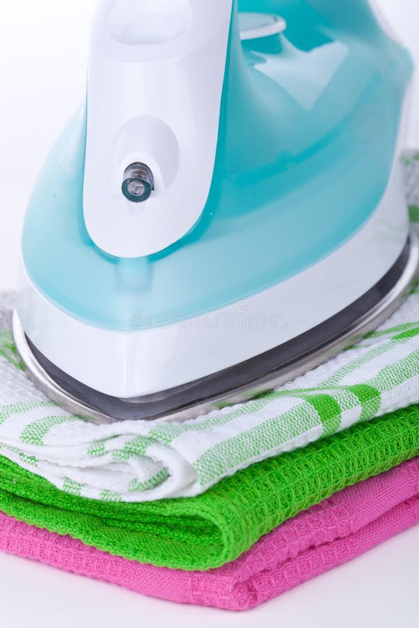 Electric iron and clothes stock photo. Image of heap 29690002