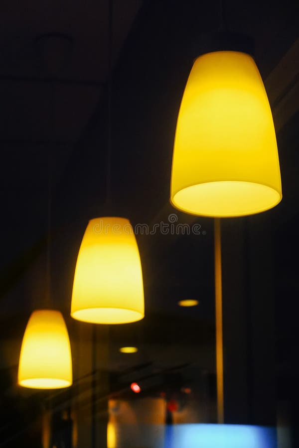 Electric Lamp Hanging from the Ceiling on Dark Background Stock Photo