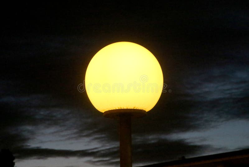 Electric Light Bulb and Sun at Beach Sunset Sky, Milan Italy Stock