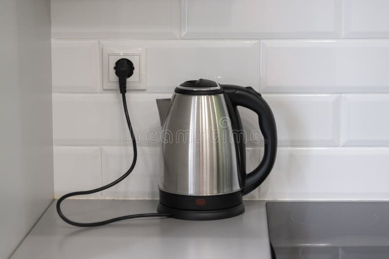 https://thumbs.dreamstime.com/b/electric-metallic-kettle-plug-socket-electric-metallic-kettle-plug-socket-white-brick-wall-behind-kettle-218681954.jpg