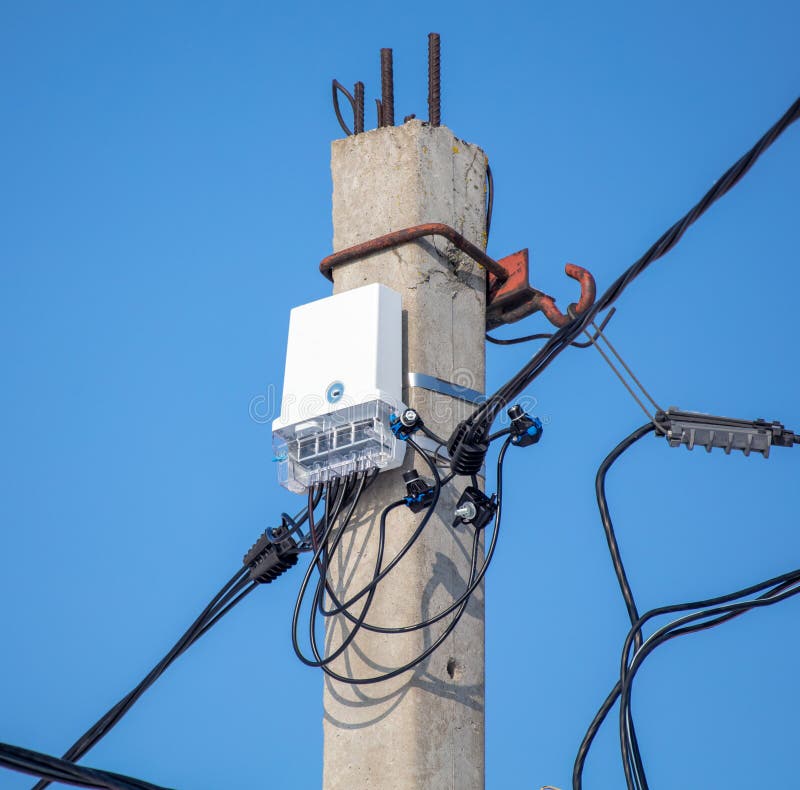 An Electric Meter on a Pole Against a Blue Sky Stock Photo Image of