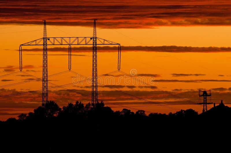 Electric power transmission lines at sunset time. Red pylons stock images, royalty-free photos and pictures