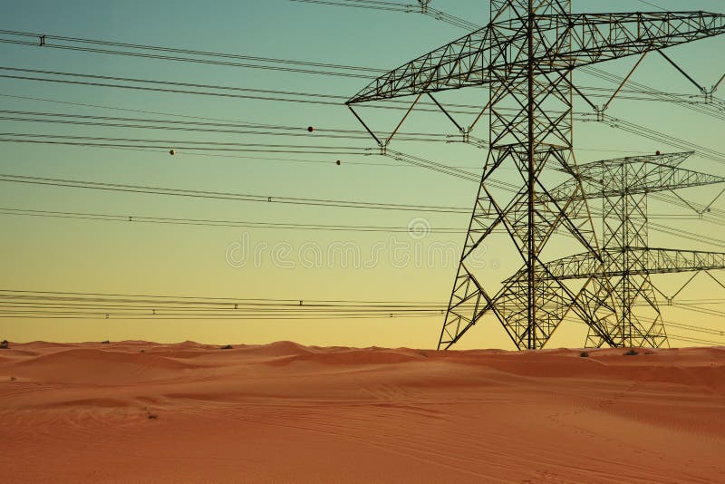 Electric power lines and electricity transmission pylons in desert at sunset royalty free stock image Electric power lines and electricity transmission pylons in desert at sunset royalty free stock image