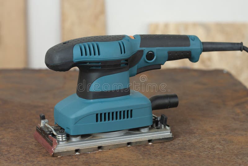 Electric Sheet Finishing Sander on Old Rusty Metal Sheet., on