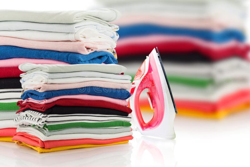 electric steam iron and Pile of colorful clothes isolated on white background. royalty free stock images electric steam iron and Pile of colorful clothes isolated on white background. royalty free stock images