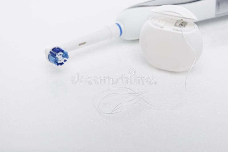 Electric Toothbrush and Dental Floss on White Stock Image Image of