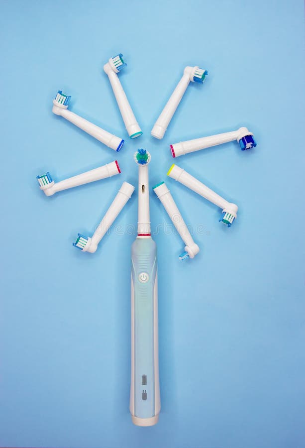 An electric toothbrush and multi-colored replaceable nozzles royalty free stock photography An electric toothbrush and multi-colored replaceable nozzles royalty free stock photography