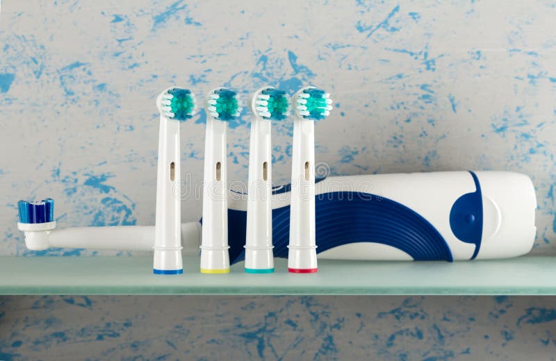 Electric toothbrush and replaceable nozzles of different colors