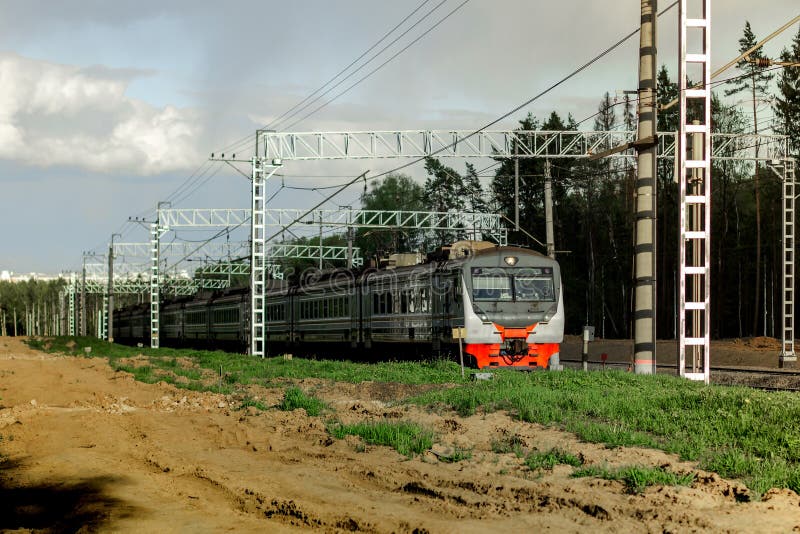 An Electric Train is Moving Slowly Along the Railway Tracks through the