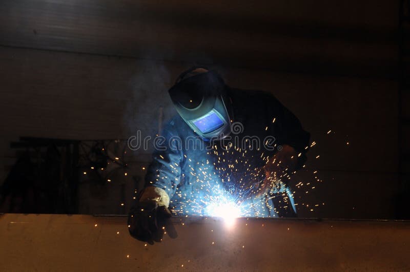 Electric Welder at Work. a Worker Welds Metal Structures at a Factory Stock Image Image of