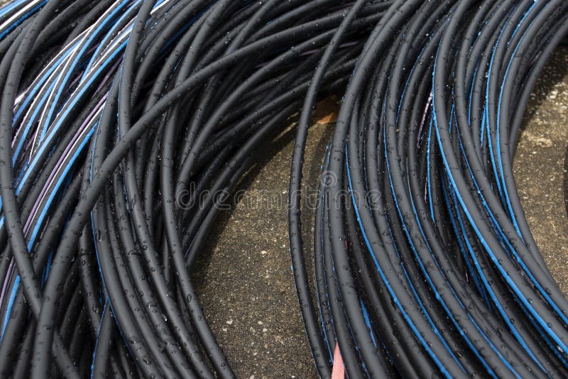 Electrical Cable after Rain. Power Cable, Wet, Raindrop Laid on Ground
