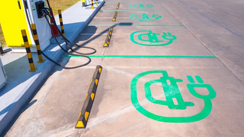 Electrical car charging sign on concrete yard floor with electric charger machine in EV station outside of hypermarket. Development ev stock images, royalty-free photos and pictures