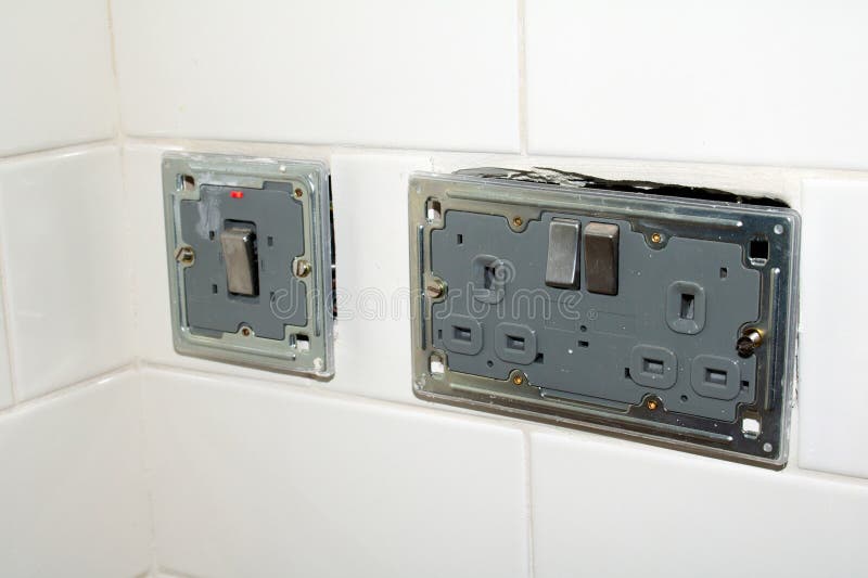 Electrical Circuit Breakers in a White Wall. Closeup Stock Photo