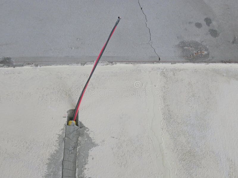 Electrical Conduit, and Wires are Installed, Secured by Cement, in a