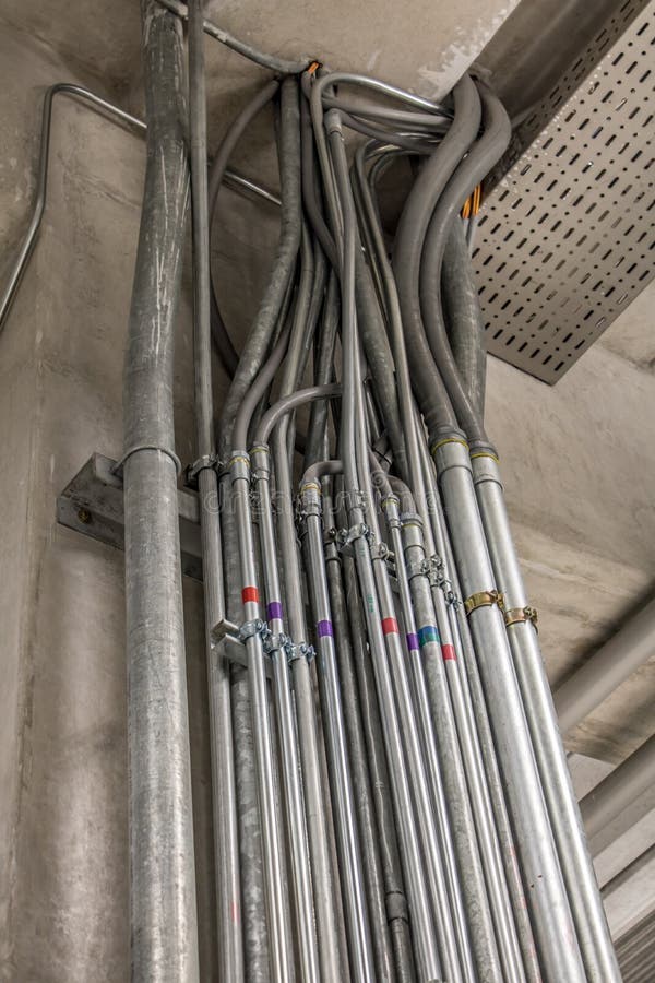 Electrical conduits system inside metal pipeline installed through building ceiling stock photography