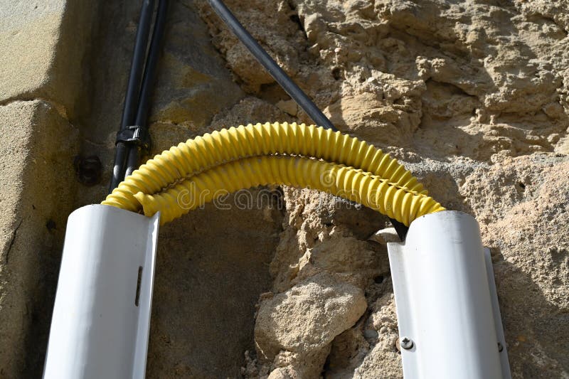 Electrical Connection Protected by a Yellow Plastic Conduit in Close Up