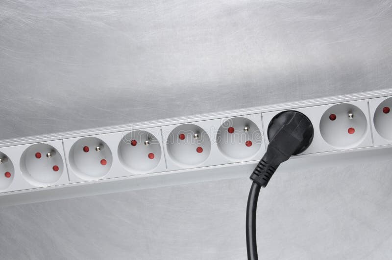 Electrical Cord with Power Strip on Grey Metal Background Stock Image