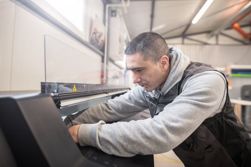 Electrical Engineer Operator Repairs Large Industrial Printer and
