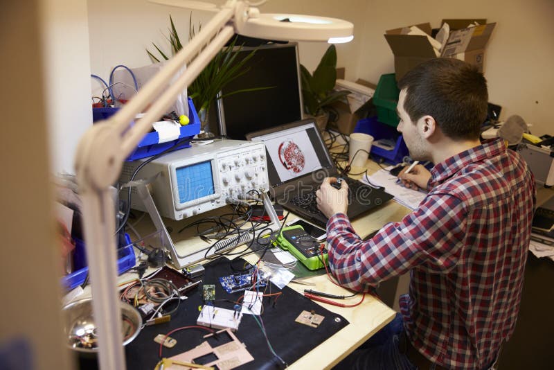 Electrical Engineer Testing Component at Work Bench Stock Photo - Image