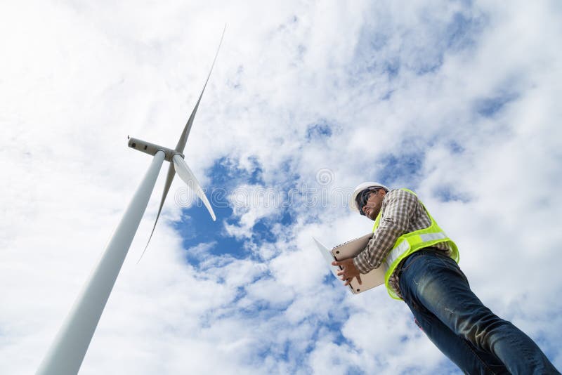 Electrical engineers working at wind turbine power generator stock photography