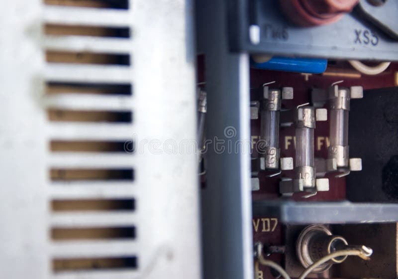 Electrical fuses on the back panel of the old tape recorder stock photography