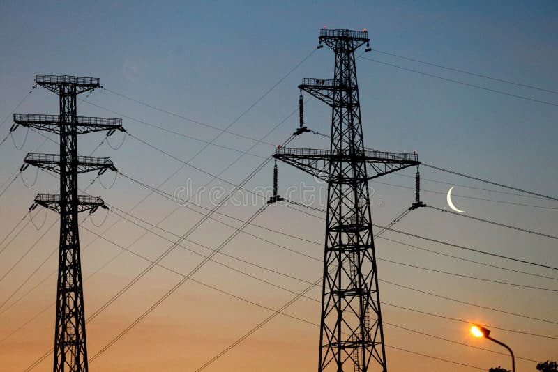 Electrical lines under a night sky with moon