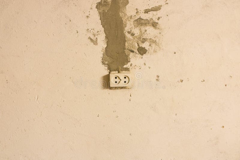 Electrical Outlet on the Old Concrete Wall. Isolated on Light