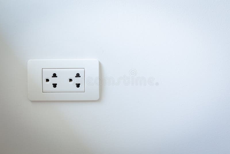 Electrical plugs on the white wall royalty free stock image