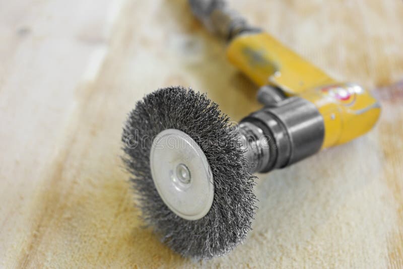 Electrical Rotating Brush Metal Disk Sanding Piece of Wood Stock Image