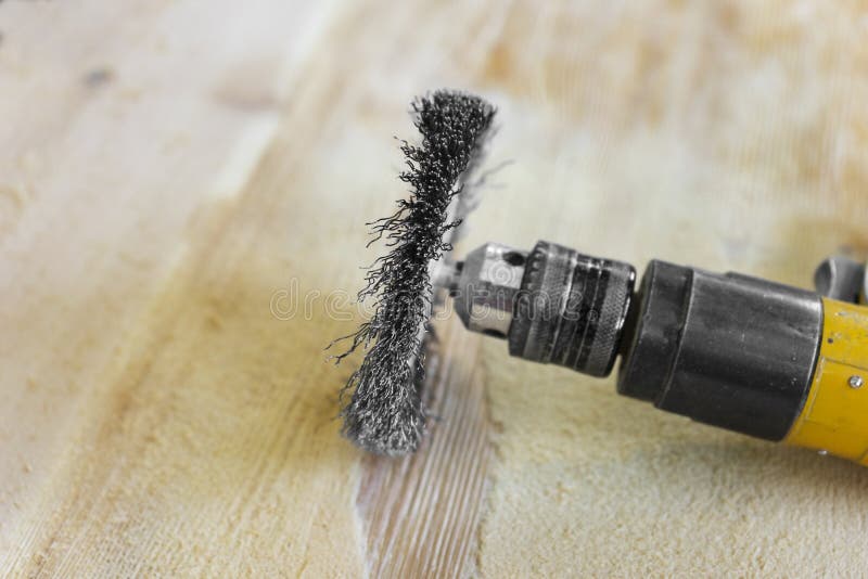 Electrical Rotating Brush Metal Disk Sanding Piece of Wood Stock Image