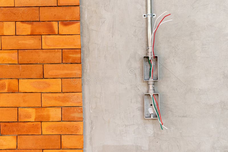 Electrical Socket Boxes with Wires on Cement Wall in a Wall Under
