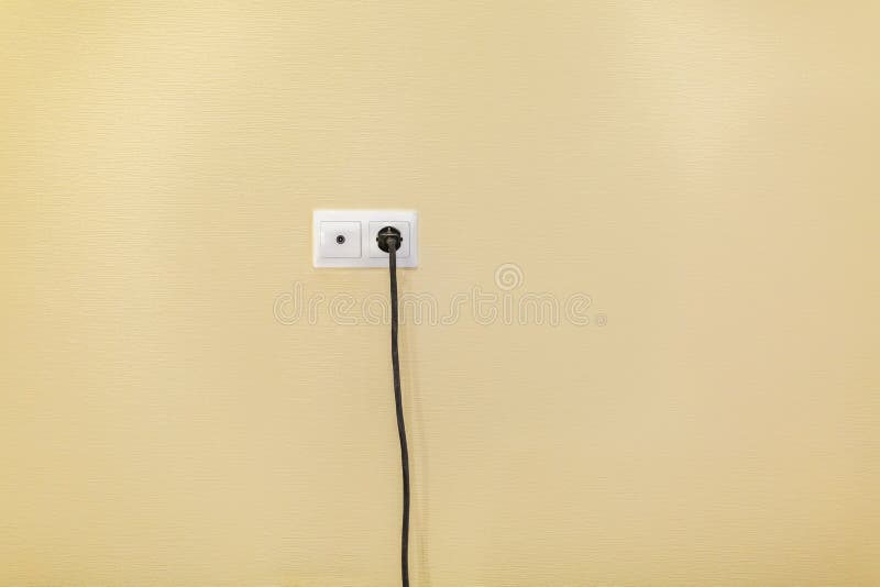 An Electrical Socket and TV Outlet on Wall with Connected Electrical Black Cable of Electrical