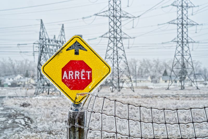 Electrical power field with freezing rain. Electrical tower and stop sign near a power plan field with freezing rain in Laval, Quebec, Canada royalty free stock photos Electrical power field with freezing rain. Electrical tower and stop sign near a power plan field with freezing rain in Laval, Quebec, Canada royalty free stock photos