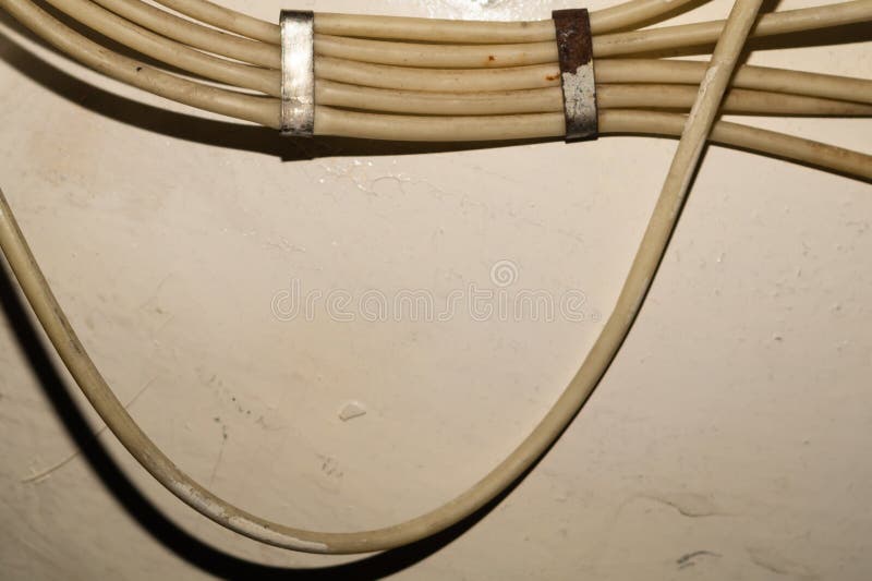 Electrical Wires or Cables Hanging on Wall. Industrial Background Stock