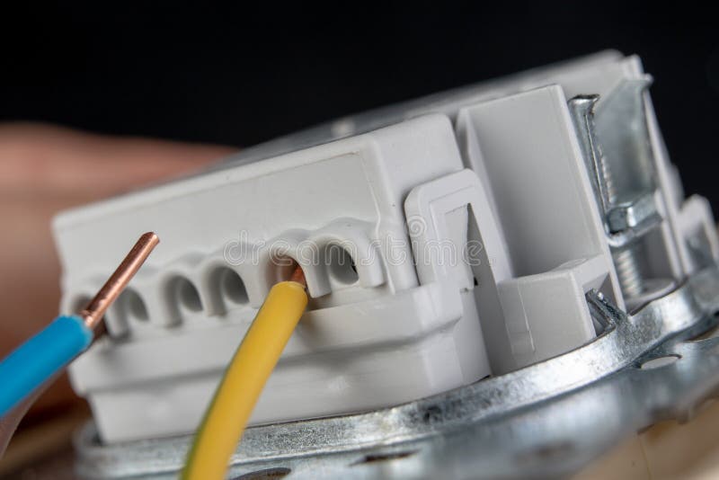 Electrical Wires Mounted To an Electrical Outlet. Electrical