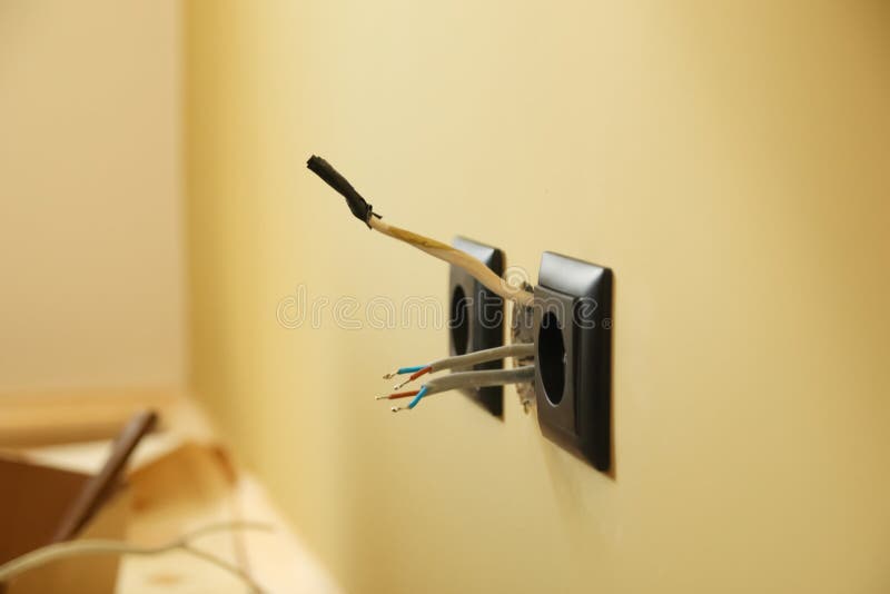 Electrical Wiring Concept. Black Electrical Socket with Wires and Tools