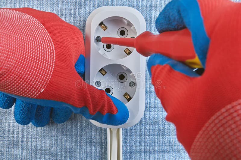 Electrical Wiring Installation, Twisting Screws of Outlet Stock Image
