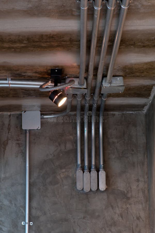 Electrical Wiring Work in a Steel Pipe of a House with a Loft Style