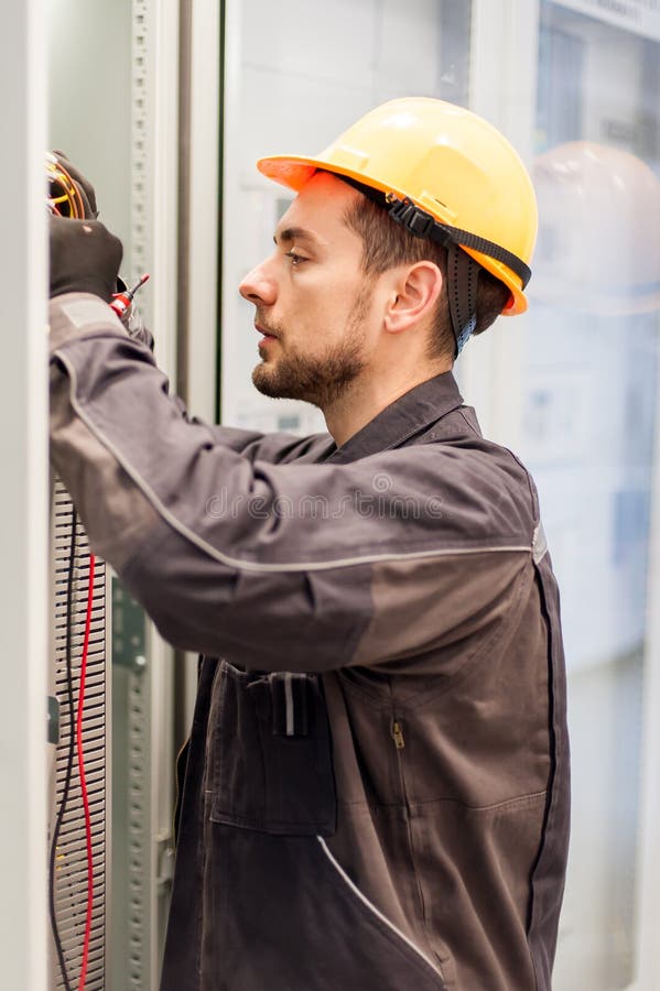 Electrician engineer tests electrical installations on relay pro stock photography