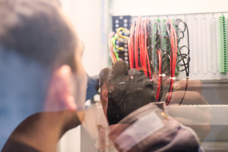 Electrician engineer tests electrical installations on relay pro stock photo