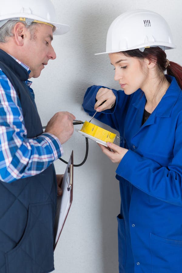 Electrician explaining to apprentice stock photography Electrician explaining to apprentice stock photography
