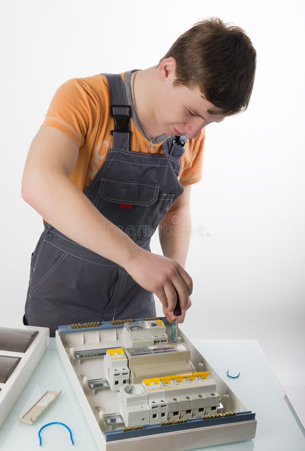 Electrician fixing cable in domestic electrical box stock photos Electrician fixing cable in domestic electrical box stock photos