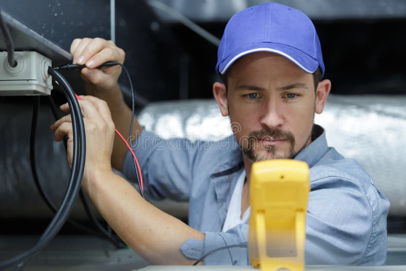 Electrician fixing electric cable royalty free stock photos Electrician fixing electric cable royalty free stock photos
