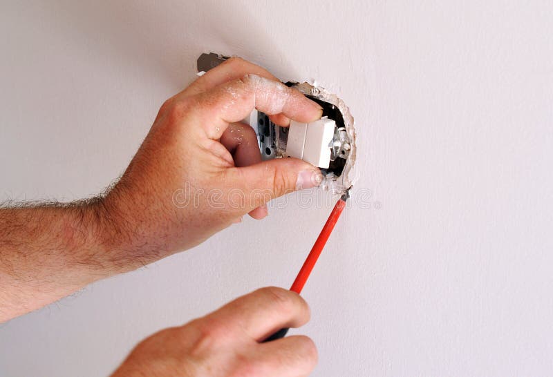 Electrician installing electrical switches royalty free stock photography