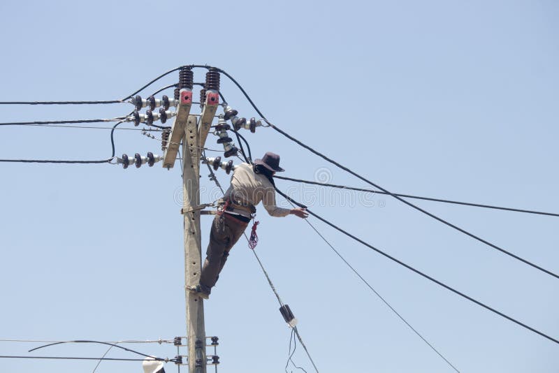 Electrician is Installing an Electrical Wiring System on a Power Pole