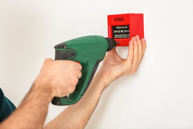 Electrician installing fire alarm on wall royalty free stock photos Electrician installing fire alarm on wall royalty free stock photos