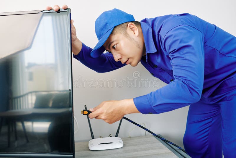 Electrician Installing Tv Set Stock Photo Image of indoors, smiling