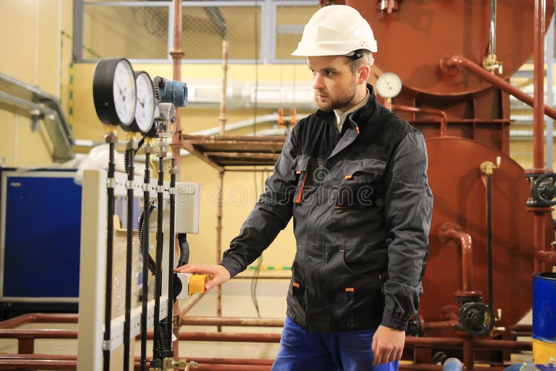 Electrician operator inspect and checking heating ventilated and air conditioning equipment. HVAC engineer checking manometer royalty free stock photo